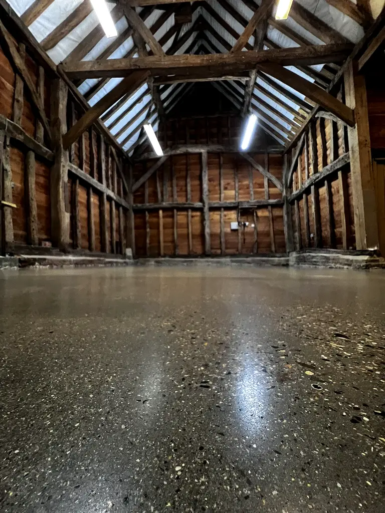 Polished exposed aggregate concrete floor in a Grade II listed barn, Pinner