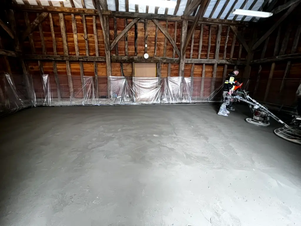 Polished exposed aggregate concrete floor in a Grade II listed barn, Pinner