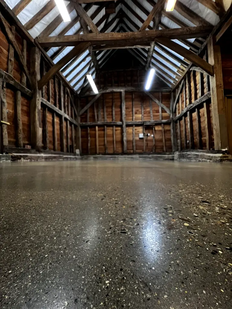 Polished exposed aggregate concrete floor in a Grade II listed barn, Pinner