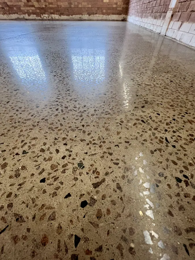 Ground and polished concrete floor with terrazzo-like aggregate at Pall Mall Deposit, Notting Hill