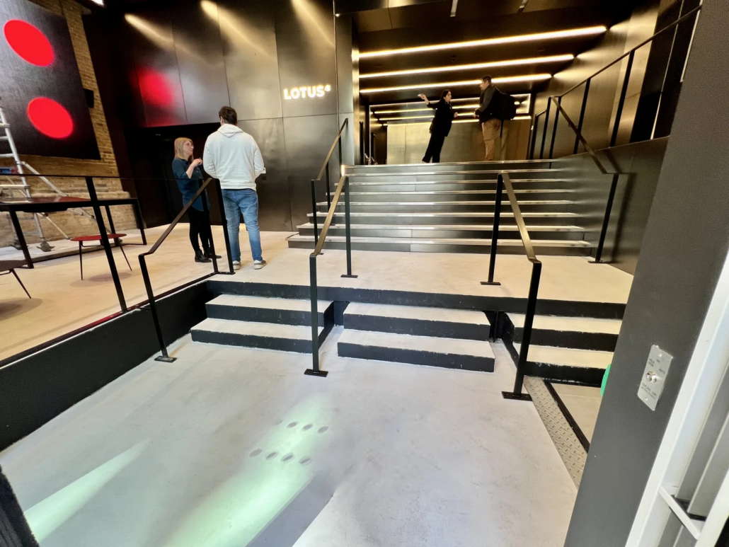 Entrance steps and microcement floor, finished showroom — Lotus Cars London HQ