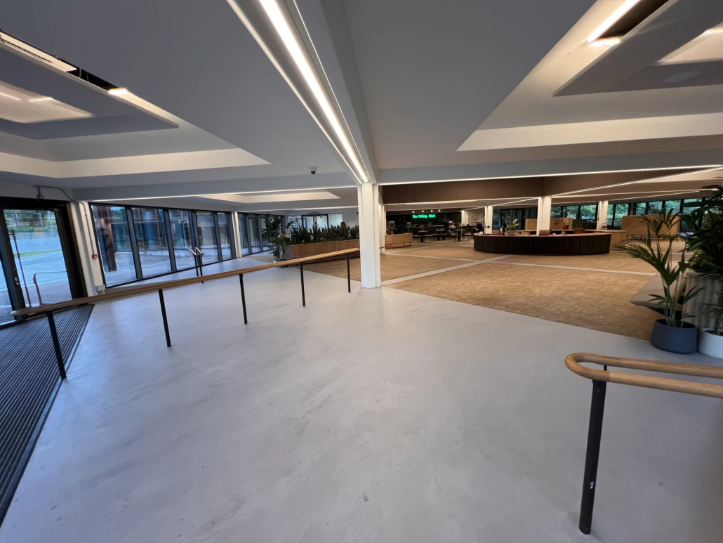 Long microcement floor run with bench seating — The AA HQ, Basingstoke