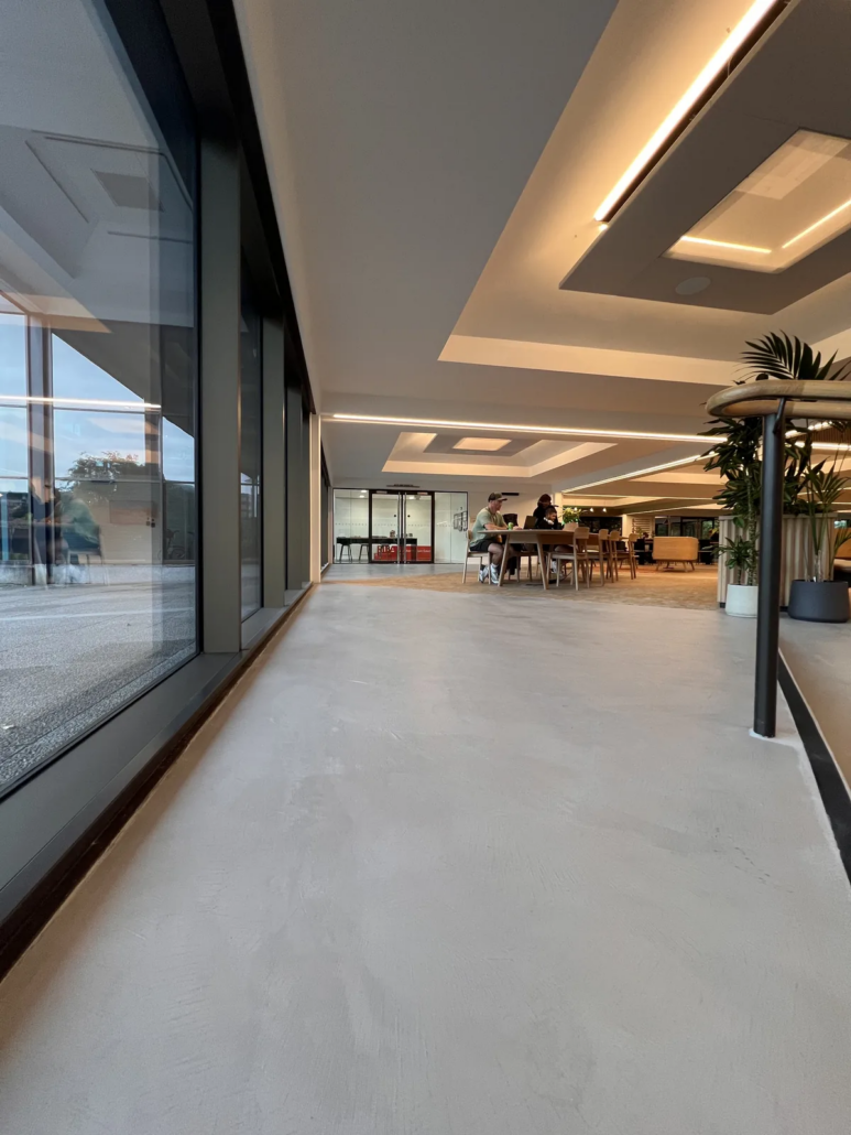 Microcement floor along the glazed elevation — The AA HQ, Basingstoke