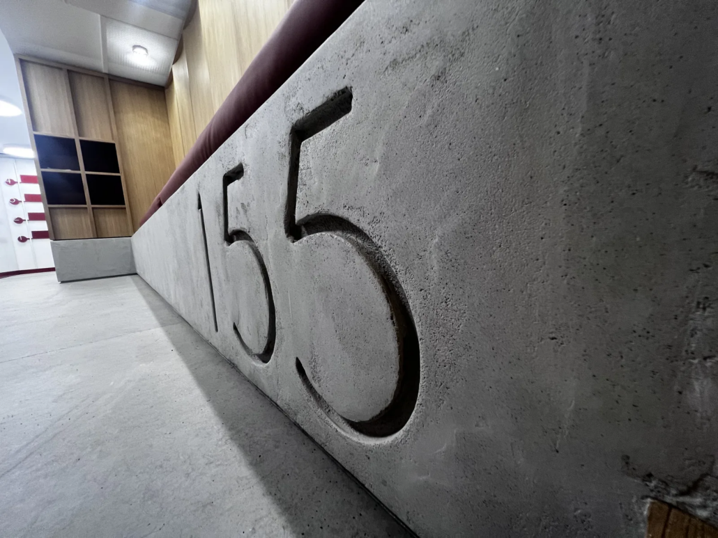 Cast concrete 155 detail above upholstered seating — J.Lindeberg flagship, London