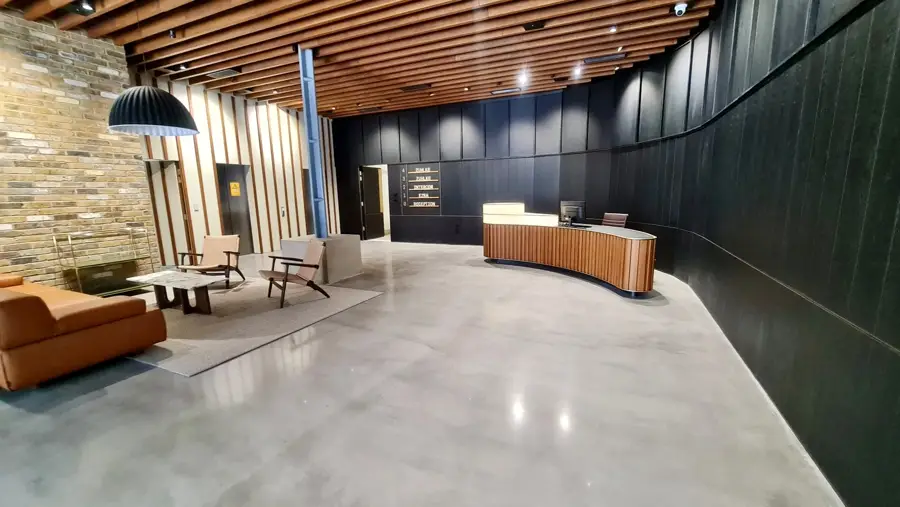 High-gloss polished concrete floor in a timber-lined commercial lobby, Great Eastern Street, Shoreditch